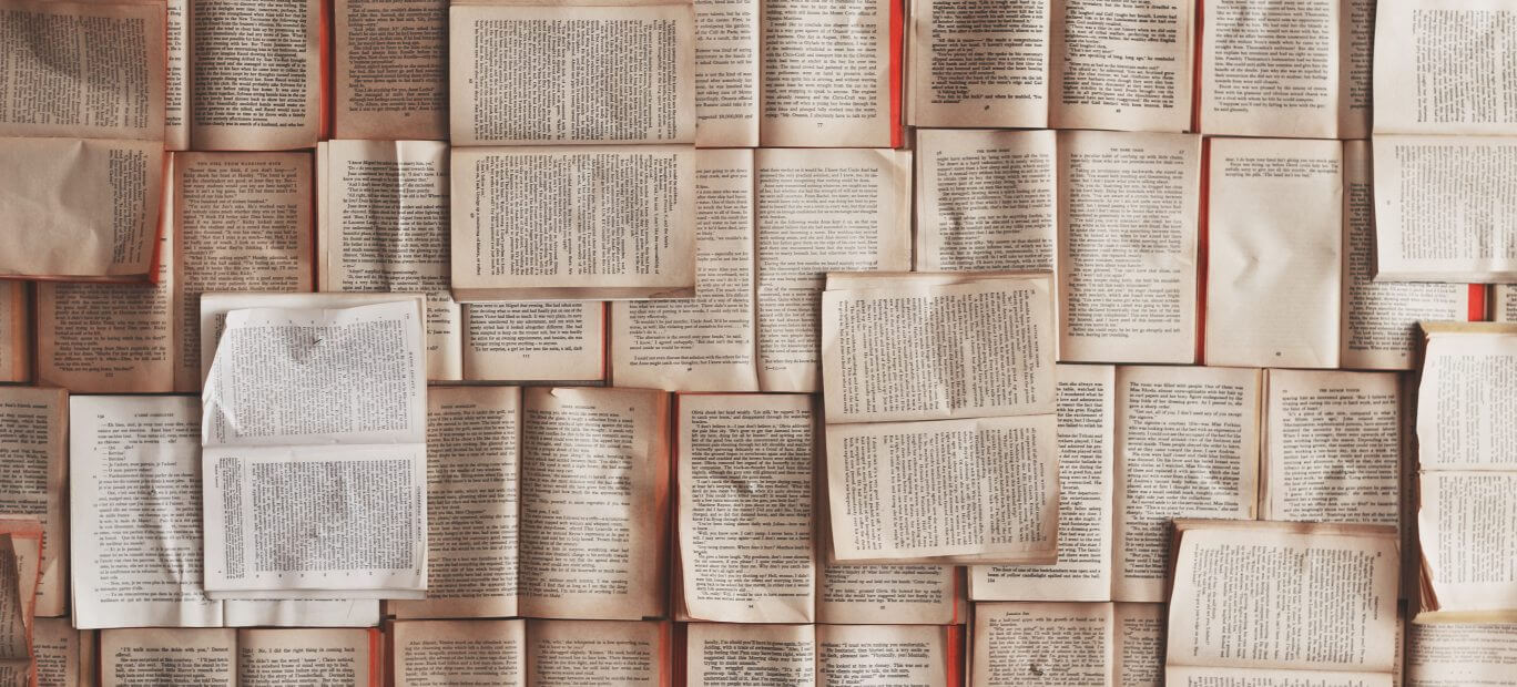 Collection of open access academic journals on a wooden table.